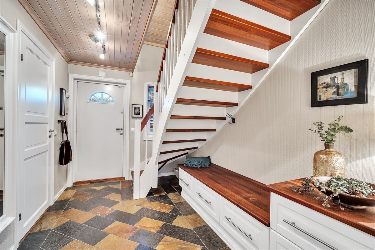 Entreen har skiferfliser, gulvvarme og flotte, plassbygde oppbevaringsløsninger. Galleribilde