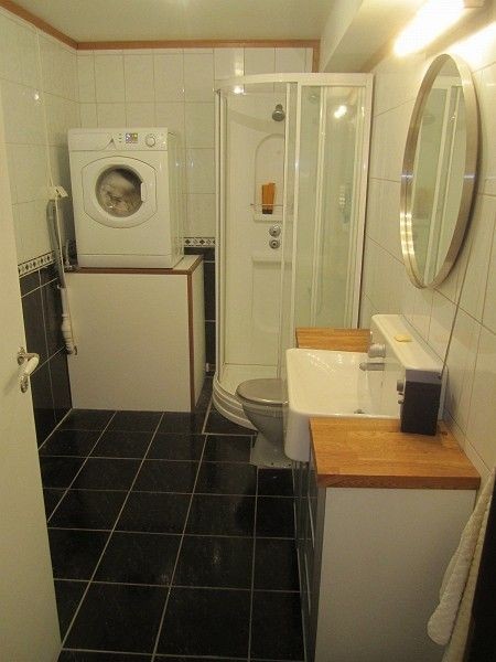 Romslig, flislagt bad med varmekabler, oppbevaringsskap vaskemaskin og plass til tørkestativ Galleribilde