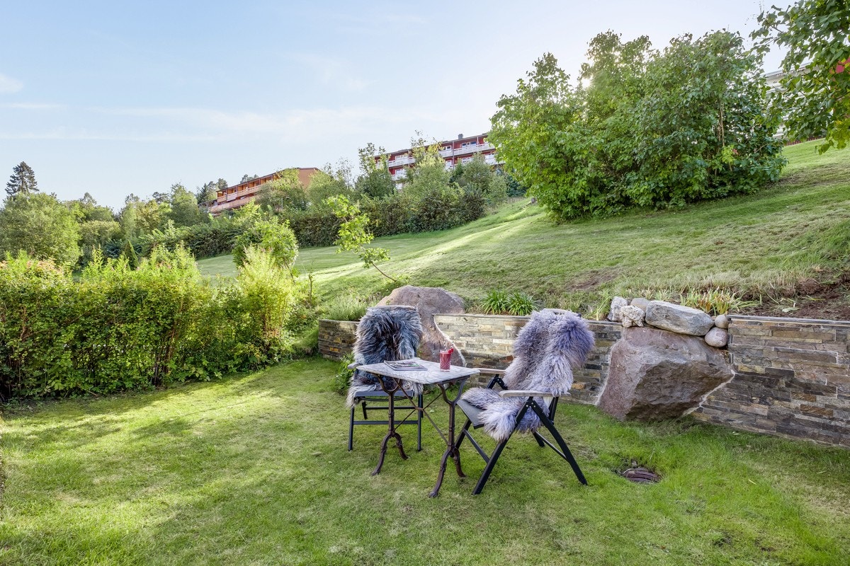 Fra både kjøkken og stue er det utgang til en flott uteplass med terrasse og plen. Galleribilde