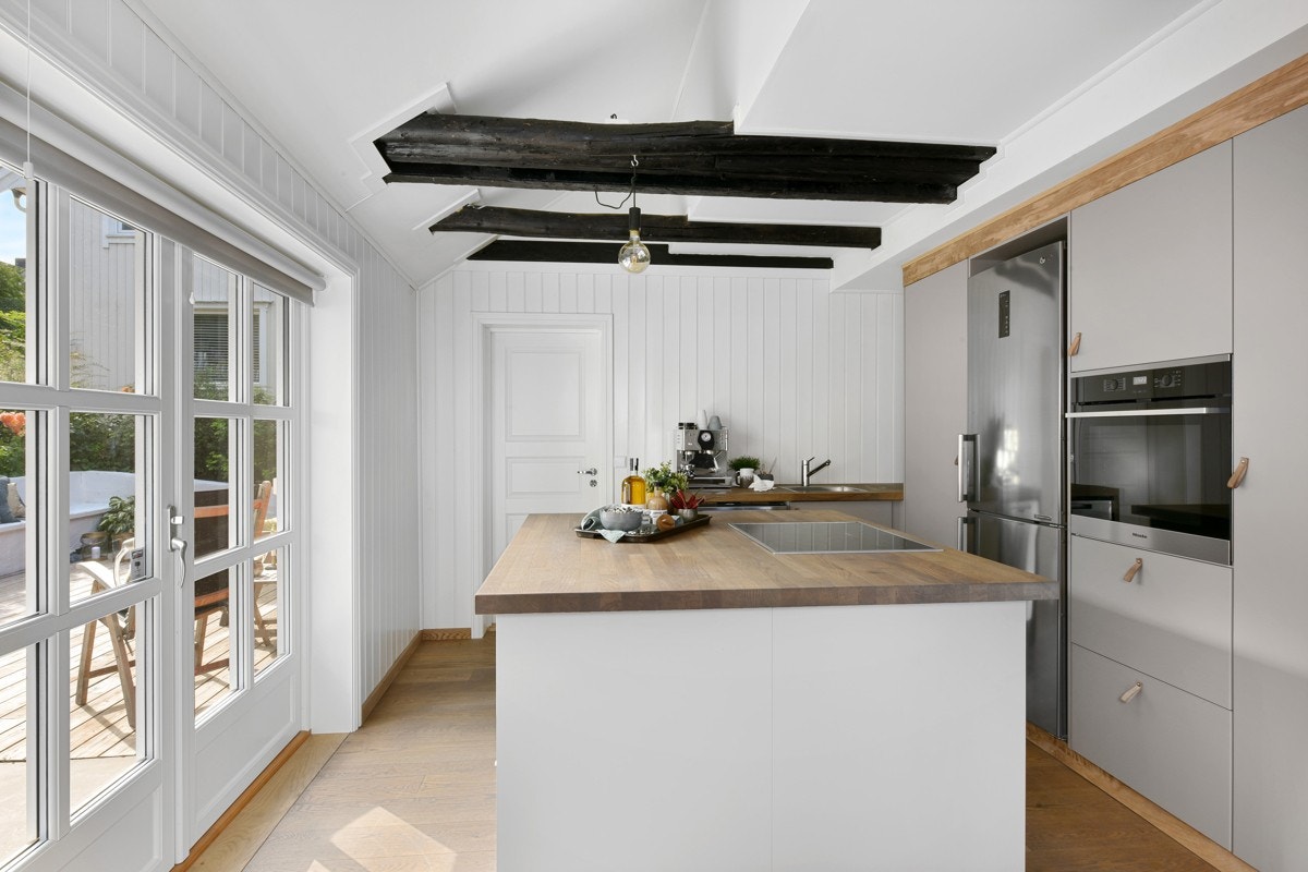 I kjøkkensonen er det en stor kjøkkenøy med heltre benkeplater. Galleribilde