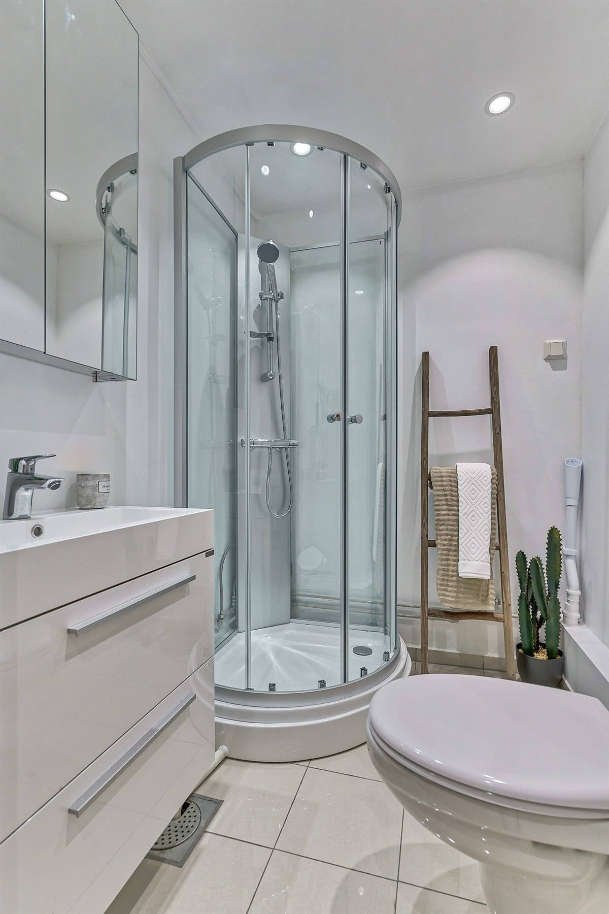 Tidløs innredning, lyse delikate fliser og downlights Galleribilde