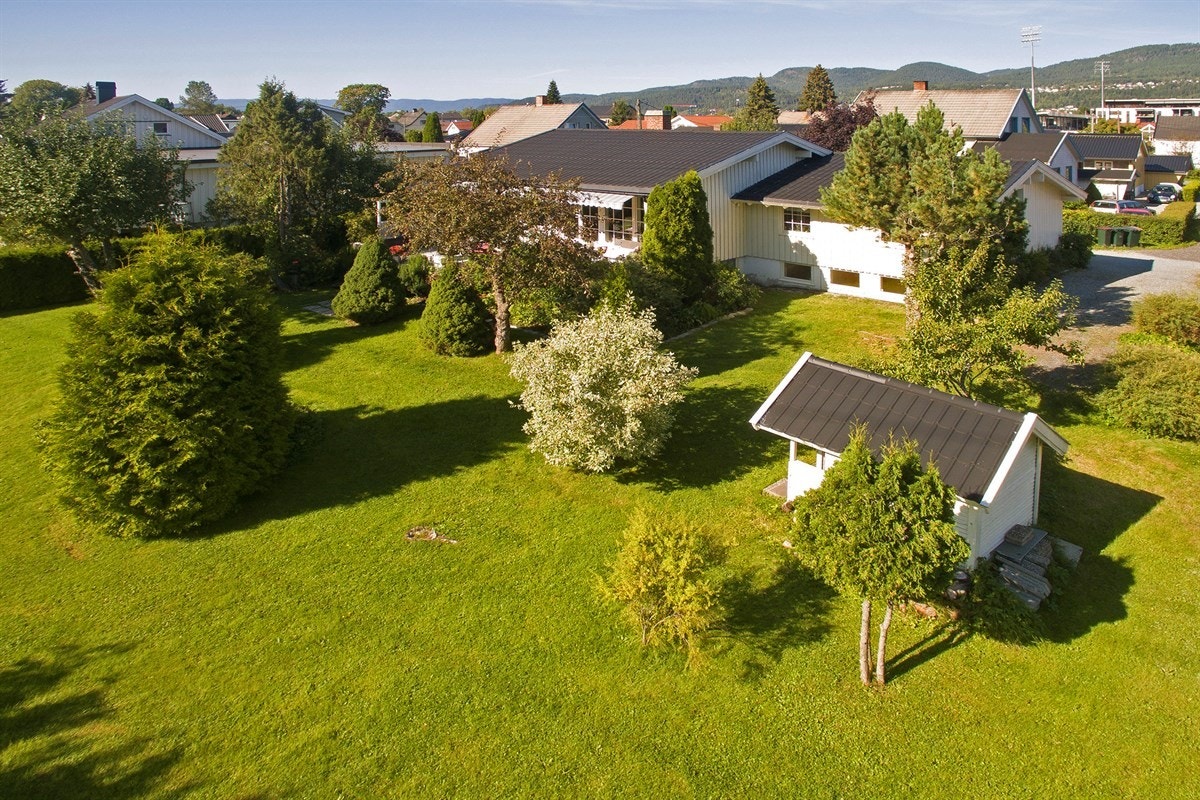 Solrik eiendom på ca.1,9 mål, hvor velstelte plenarealer omkranser boligen på flere sider. Galleribilde