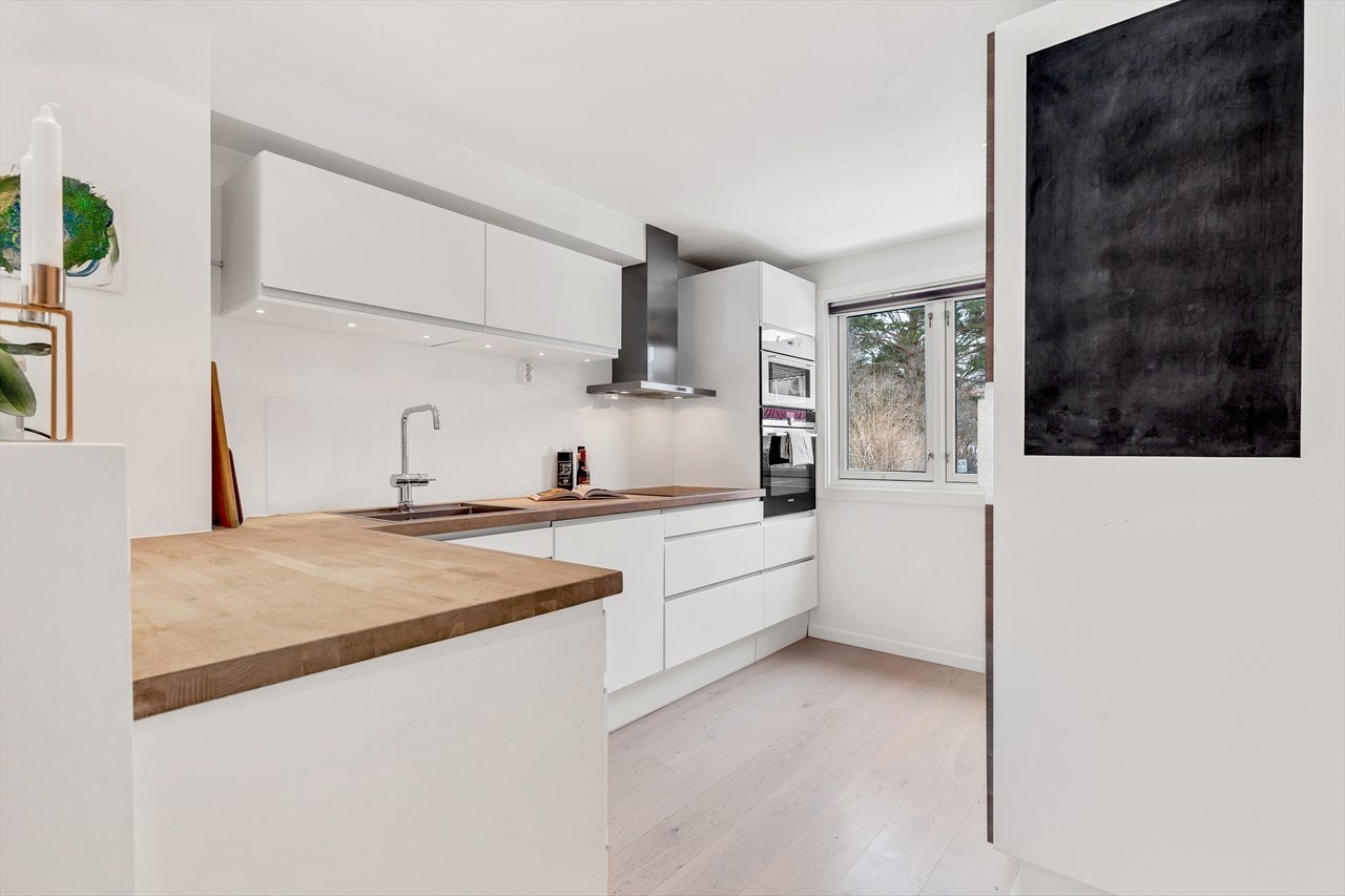 Kjøkkenviften har avtrekk ut i friluft. Integrert kjøleskap, pyrolyse komfyr, induksjonstopp, mikrobølgeovn og oppvaskmaskin. Stål vaskekum nedfelt i heltre benkeplate. Galleribilde