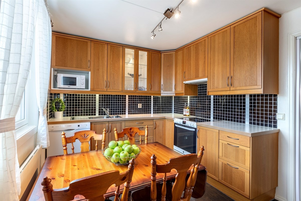 Ikea kjøkkeninnreding i eik fra 2008. Takhøye overskap, vitrineskap med lys. Galleribilde