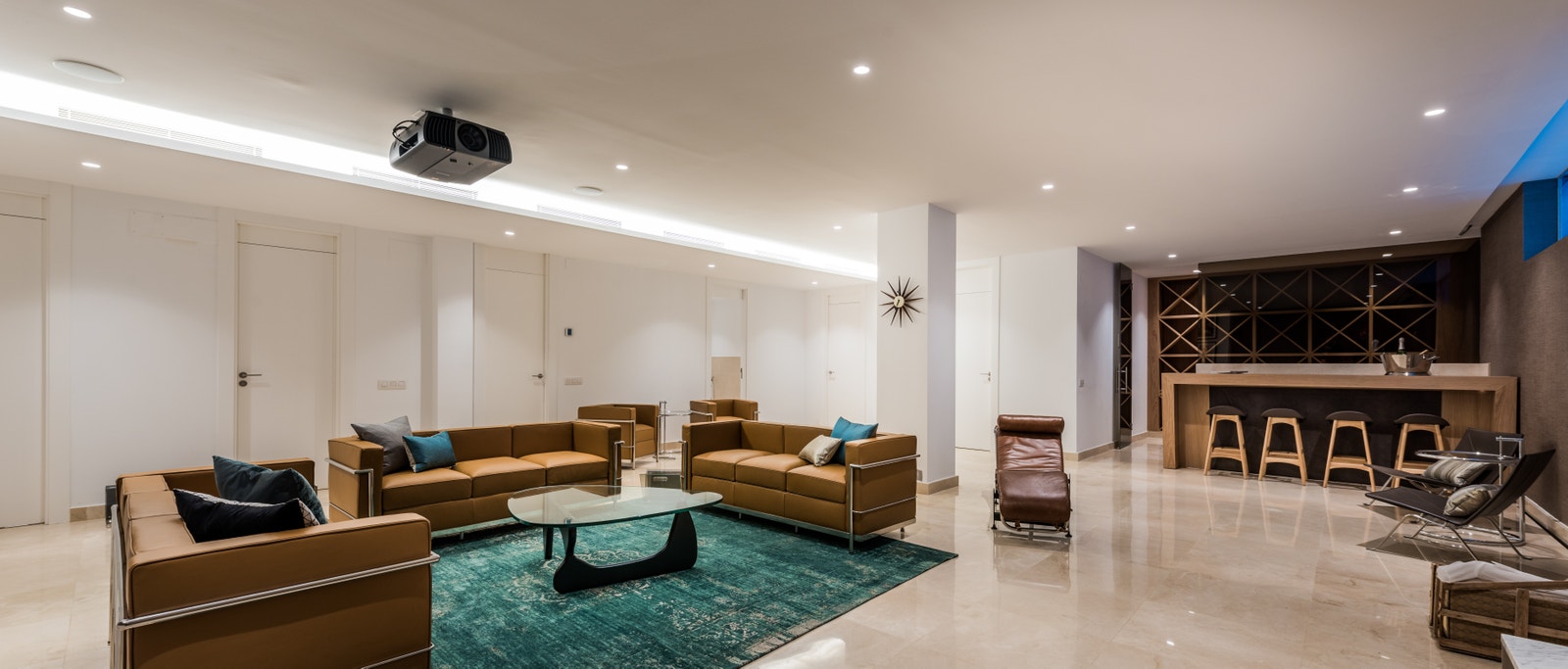 Basement media room with TV projector and bar area Galleribilde