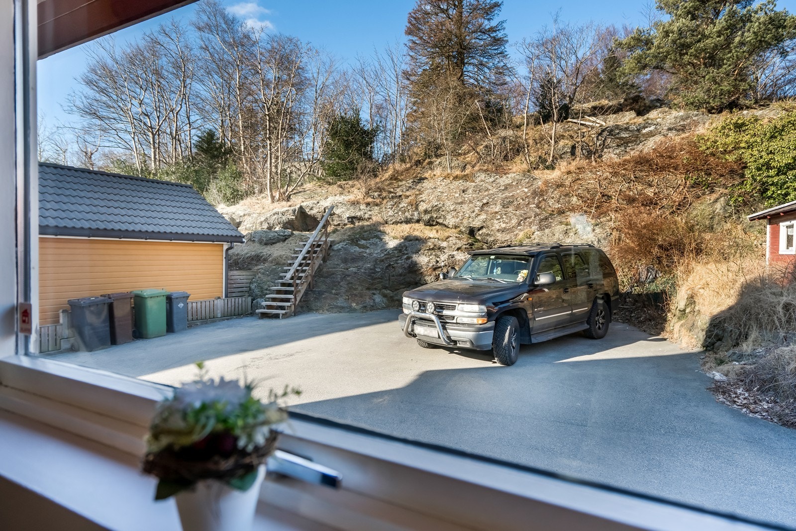 Fra kjøkken ser du opp mot Buøy skogen. Arealet tilhører eiendommen, og her har du plass til 2-3 biler. Galleribilde