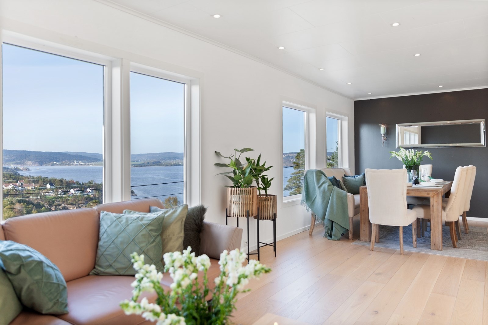 Store vindusflater gir en luftig romfølelse og man kan ikke unngå å nyte utsikten utover Topdalsfjorden og Kjevik. Galleribilde