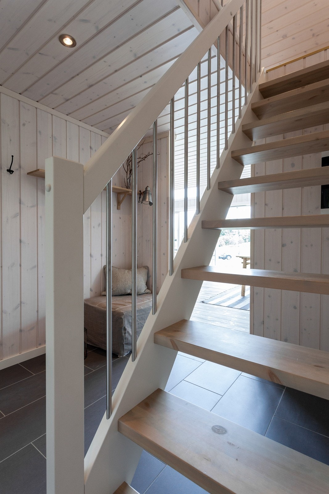 Hvitmalt trapp med stålspiller og grå eller brune trinn. Galleribilde