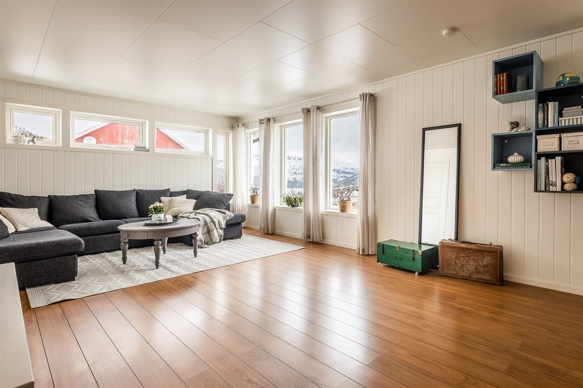 Romslig stue med store vindusflater