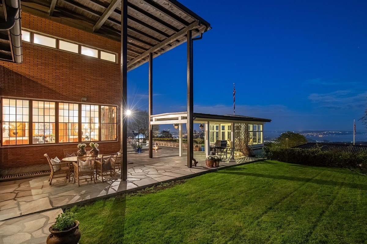 Meget velholdt og pent opparbeidet tomt med plen, prydbusker, trær og flaggstang. Galleribilde