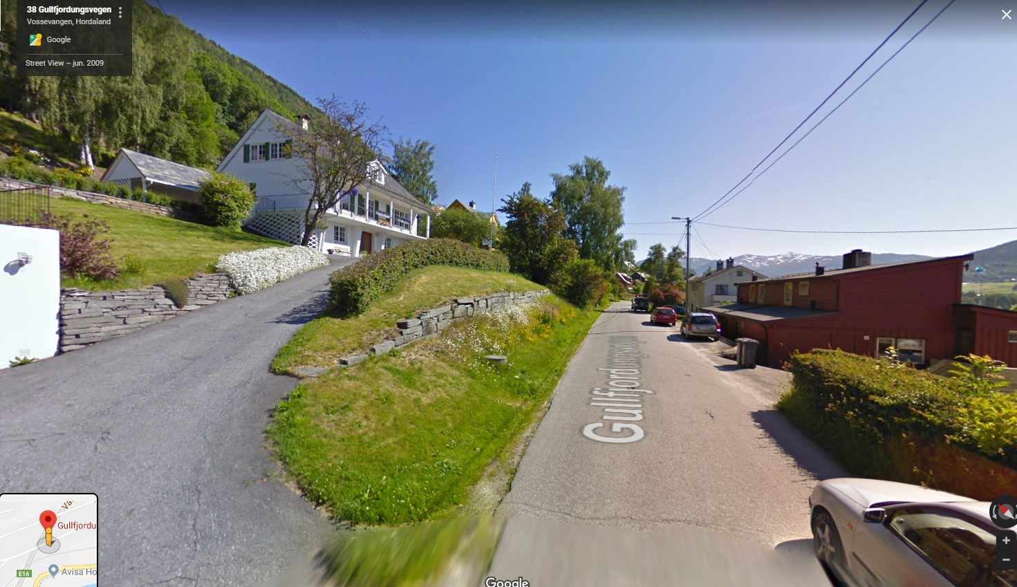 Bildet frå veg (blindveg, lite trafikk). Uteplass med tak oppe til venstre for huset i stor hage. Galleribilde