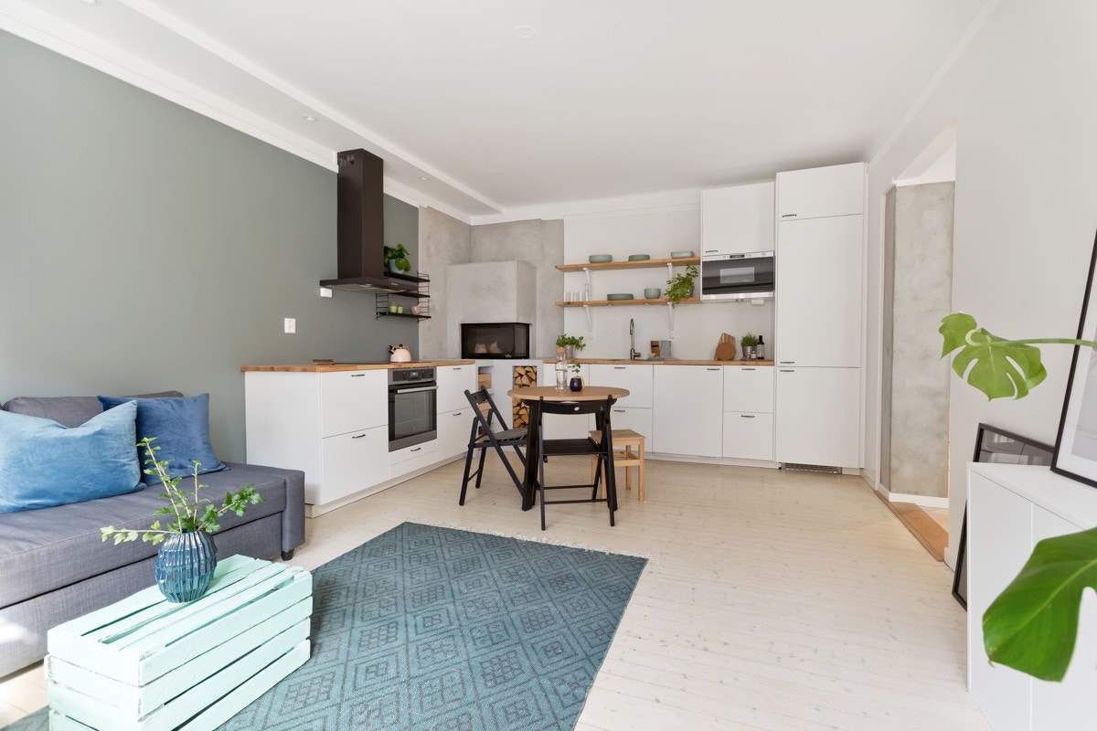 Lyse, glattlakkerte fronter fra IKEA med heltre benkeplate og nedfelt rustfri oppvaskkum. Galleribilde