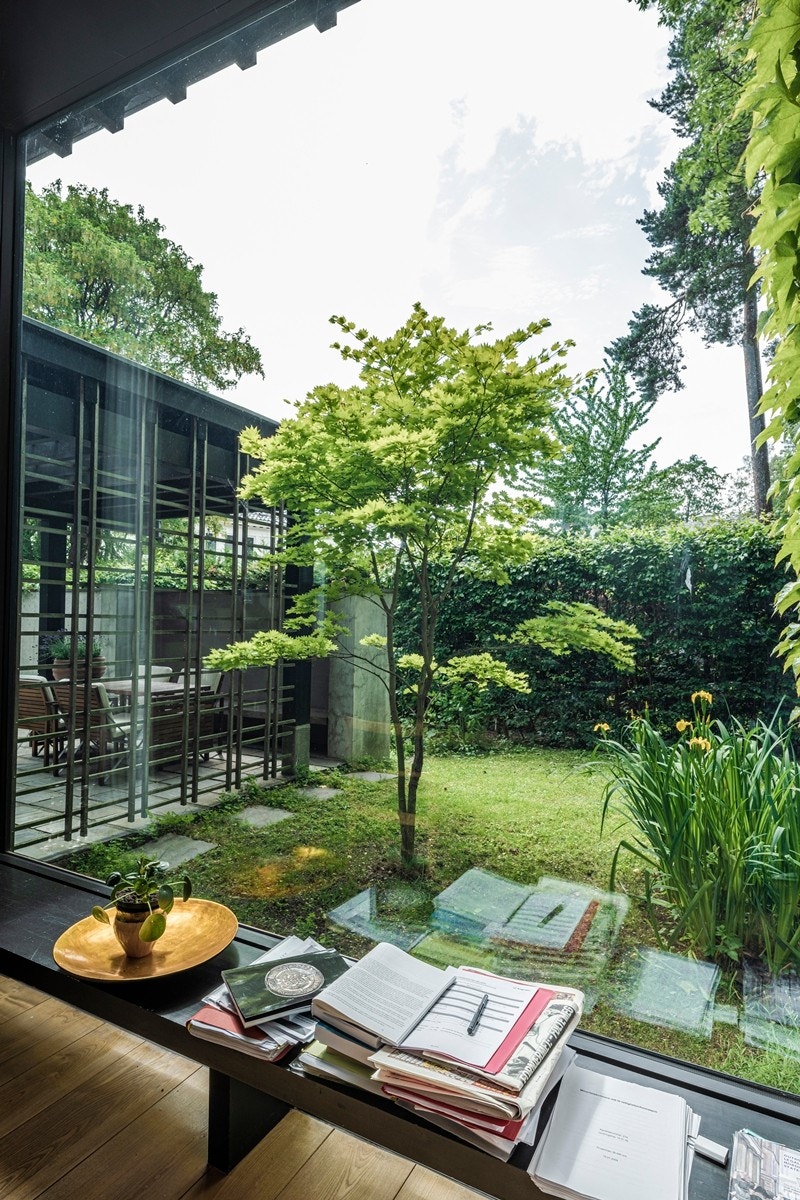 Vindu fra gulv til tak ved spiseplassen med utsyn over den flotte hagen Galleribilde