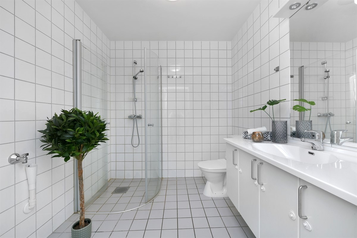 Badet har toalett, dusjhjørne med innfellbare dører og opplegg for vaskemaskin. Galleribilde