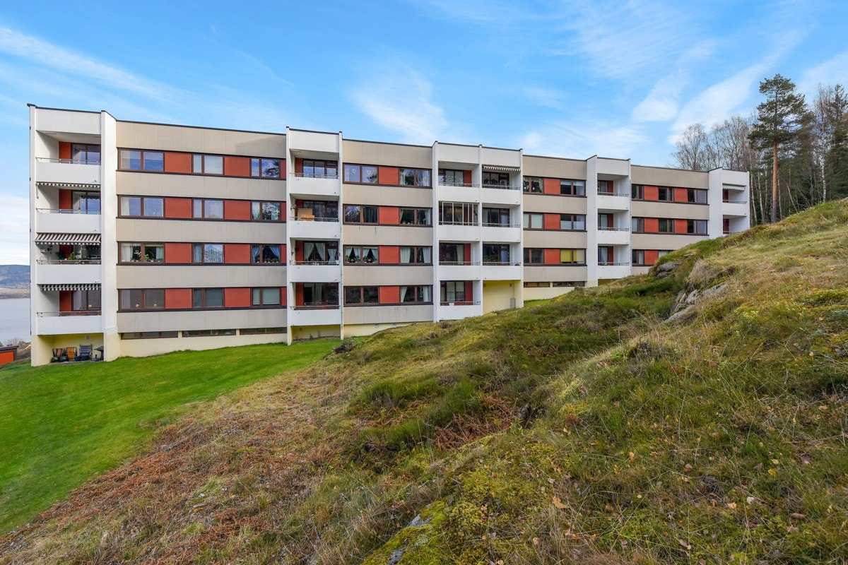 Eiendommen er opparbeidet med asfalterte områder, samt plen, prydbusker, hekker og noe fjell i dagen. Galleribilde