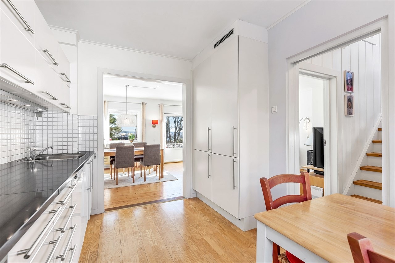 Stor åpning mellom kjøkken og stue/spisestue og ekstra innsatt vindu på stuen, gir gjennomgående naturlig lys til begge rom. Galleribilde