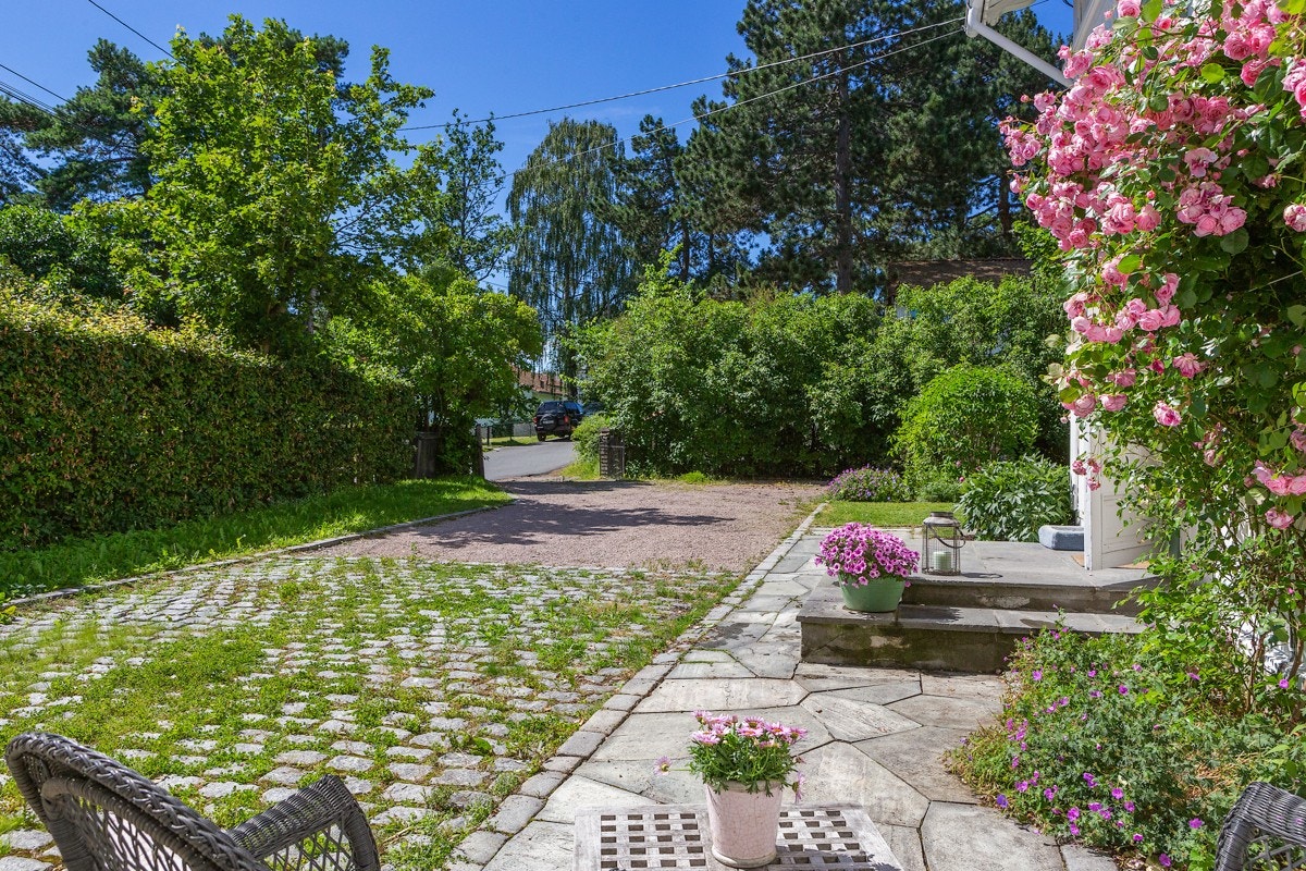 Gårdsplassen er gruset, det er brostein i front av garasjen og skiferlagt uteplass ved hovedinngangen. Galleribilde