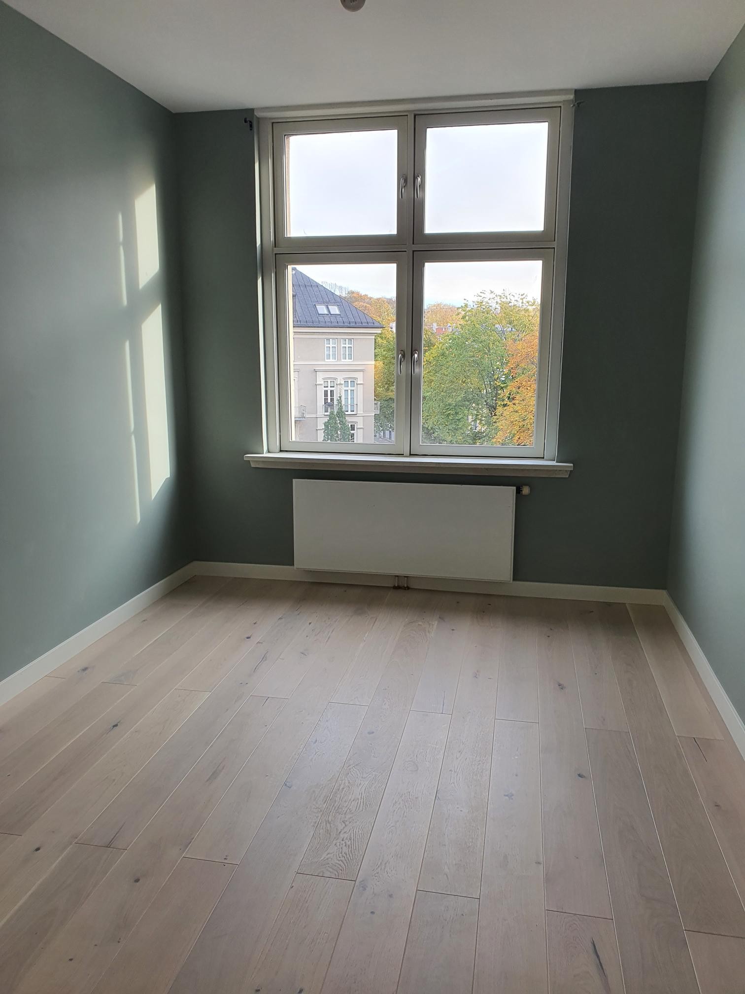 Romslig stue med god takhøyde og store vindusflater Galleribilde