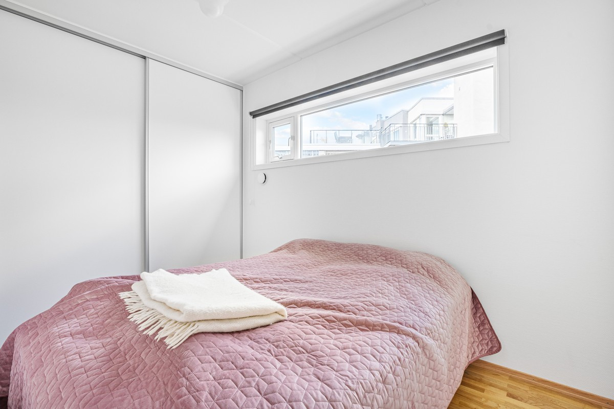 Soverom av fin størrelse med skyvedørsgarderobe og plass til stor seng og annet møblement