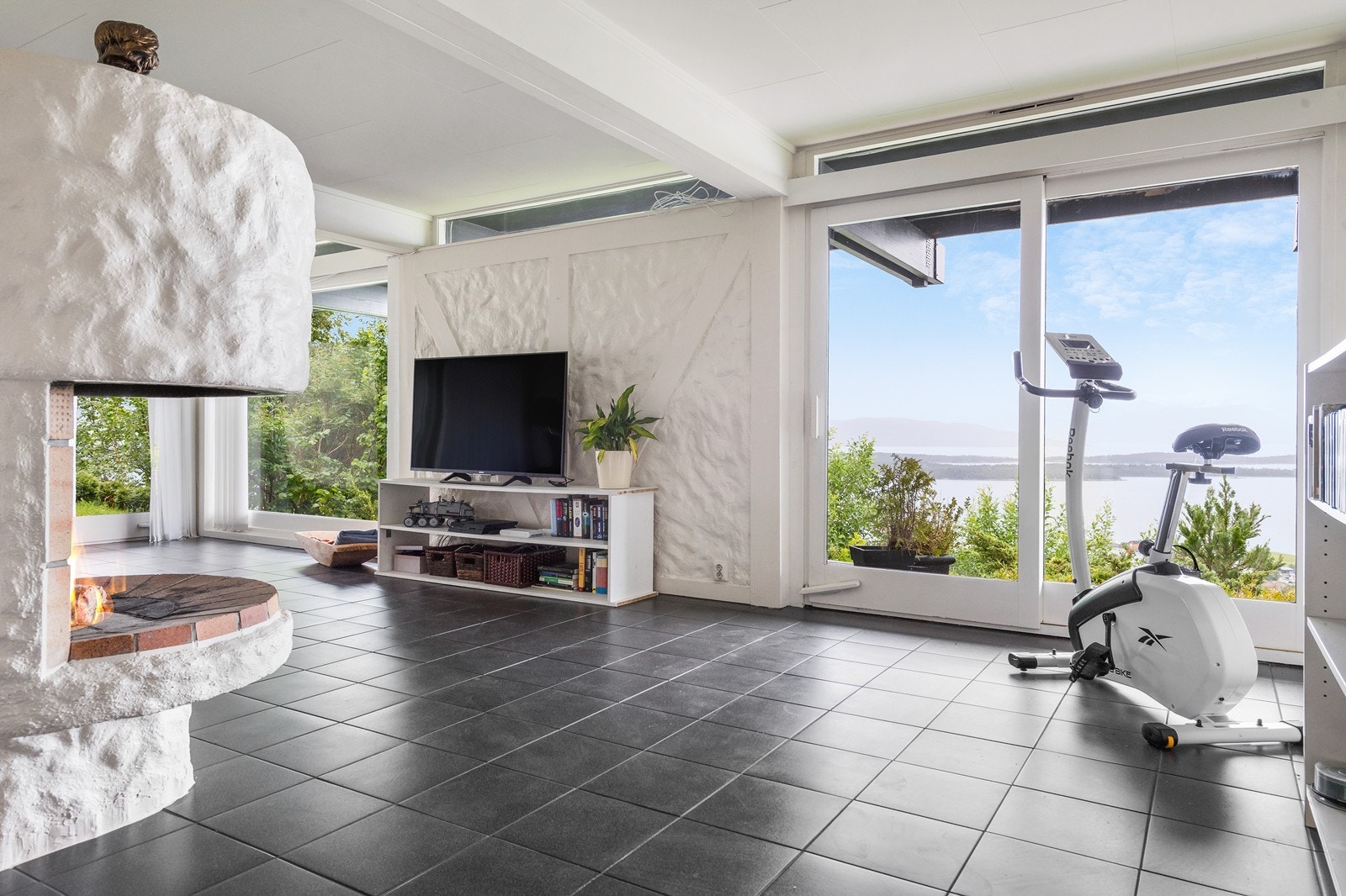 Boligen har en svært romslig kjellerstue/peisstue. Også her er det naturligvis fantastisk utsikt! Galleribilde