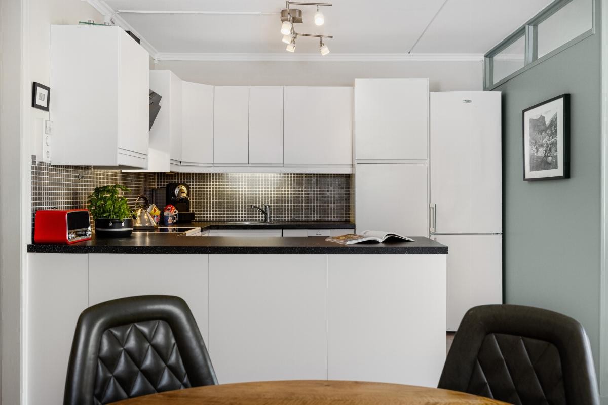 I kjøkkenet er det en praktisk barløsning som utvider arbeidsflatene betraktelig og fungerer som romdeler Galleribilde