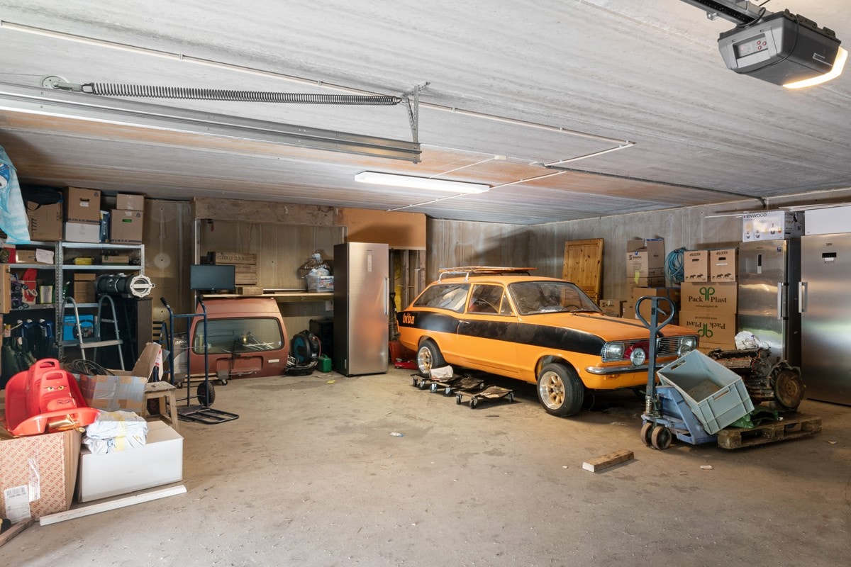 Felles stor garasje med eget seksjonsnummer. I halvdelen som denne leiligheten benytter er det plass til 3 biler + verksted. Galleribilde