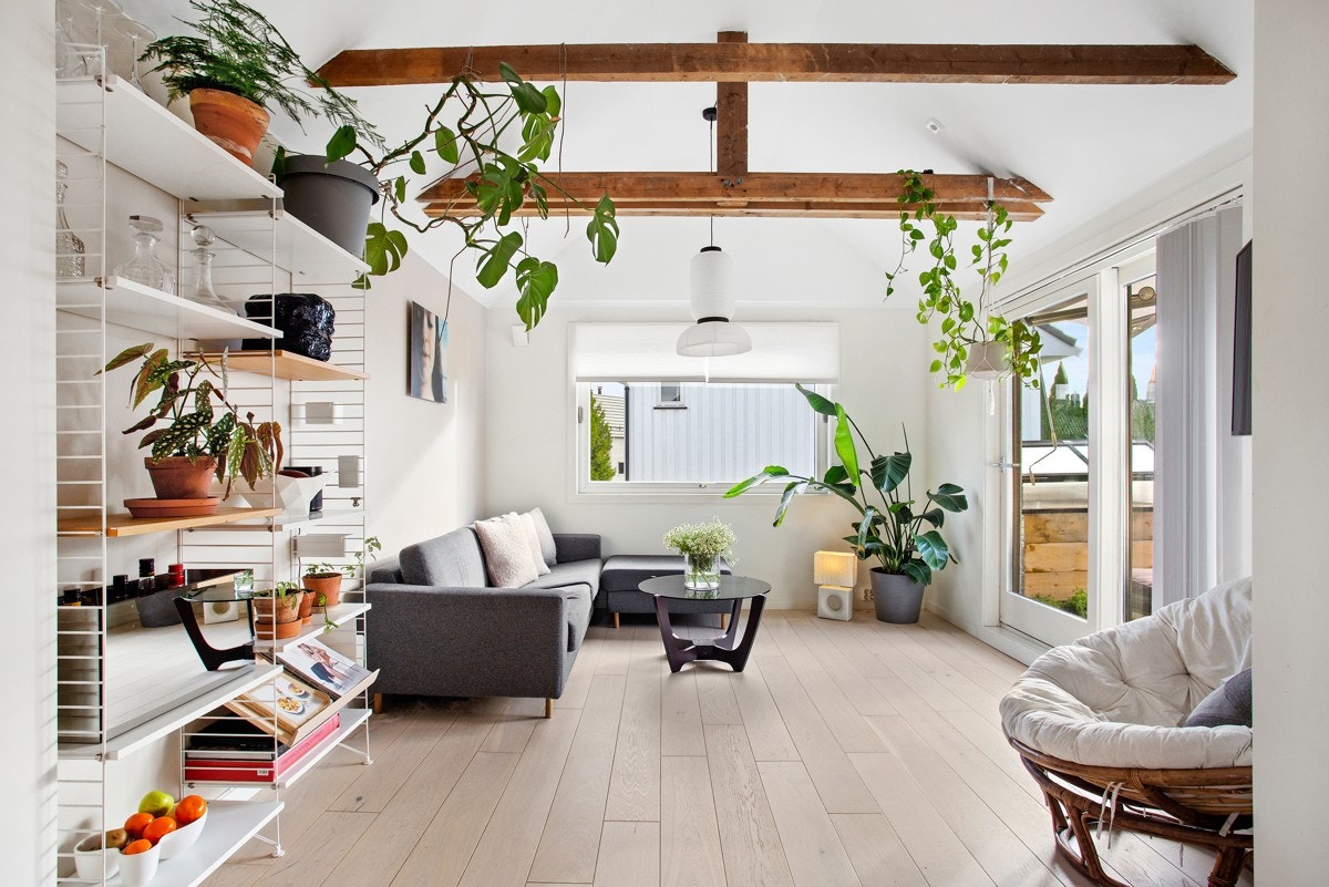 Den deilige stuen har enstavs parkett på gulv og dempet veggfarge, listefritt til skråtak, hvor det er brunbeisede dragere Galleribilde