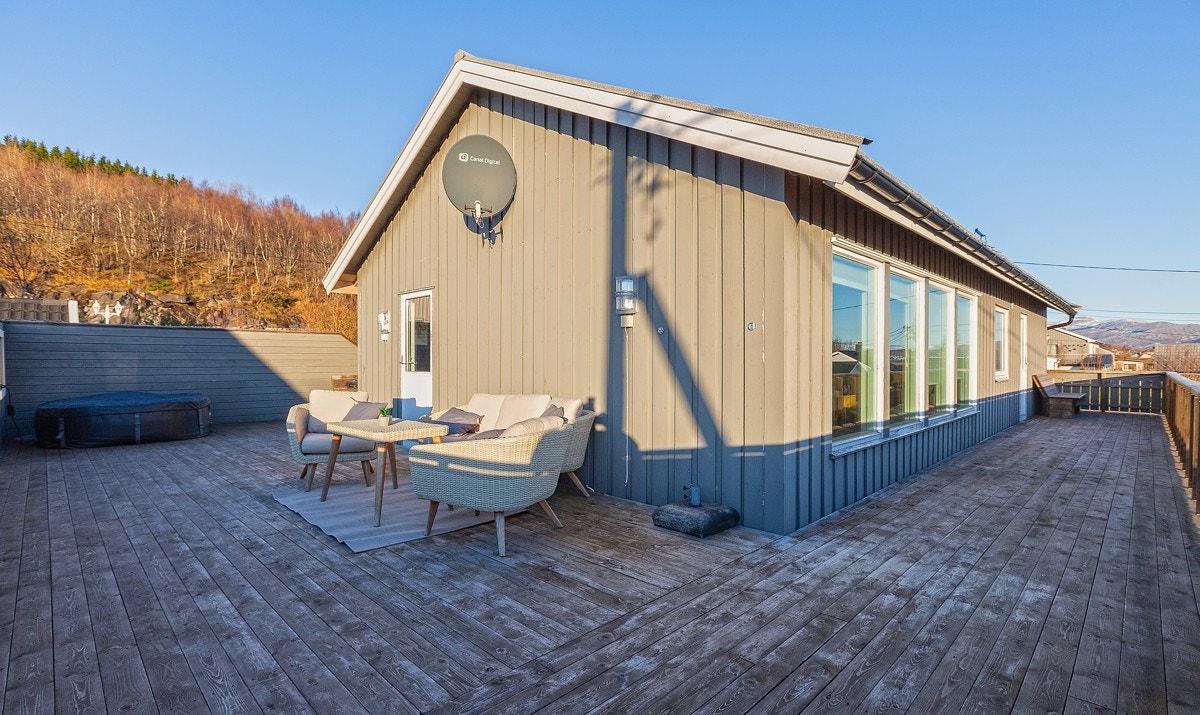 Mot nordvest er det laget høy levegg som skaper en lun krok. Verandaen som strekker seg rundt hele solsiden - sikrer solstråler hele dagen. Galleribilde