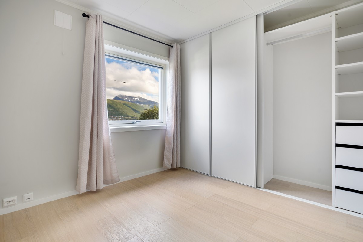 Soverom 1 med stor og praktisk skyvedørsgarderobe med innredning. De fleste vinduer med manuelle plissegardiner og noen fortrekksgardiner
