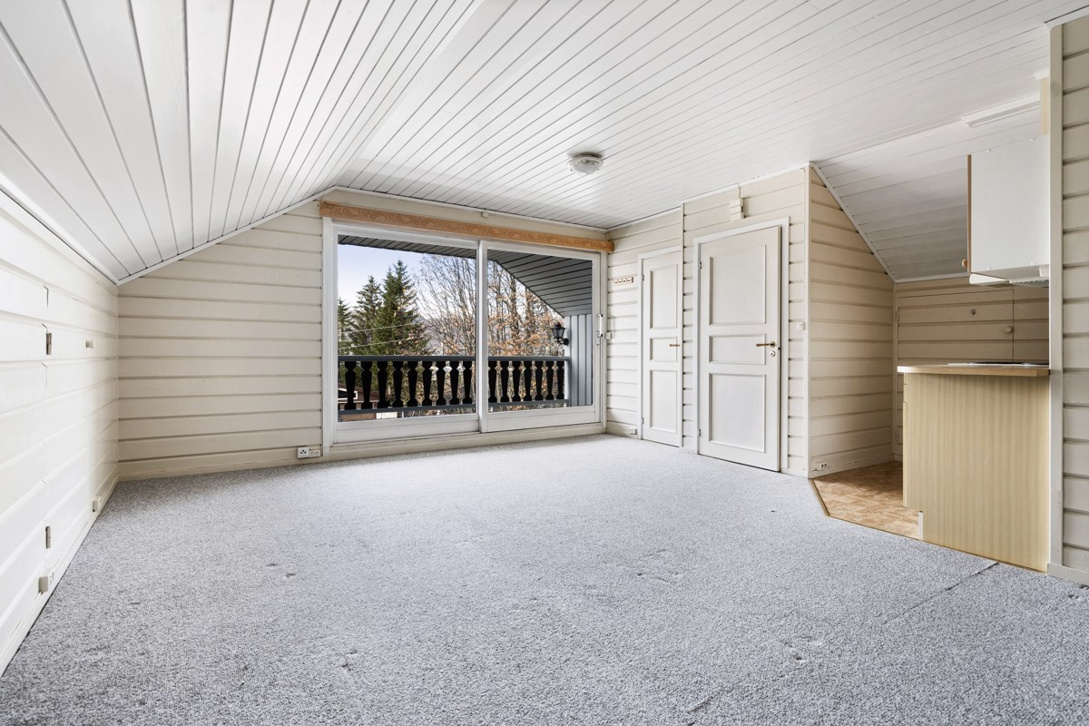 Loftstue med lite kjøkken og utgang til vestvendt veranda i 2. etasje