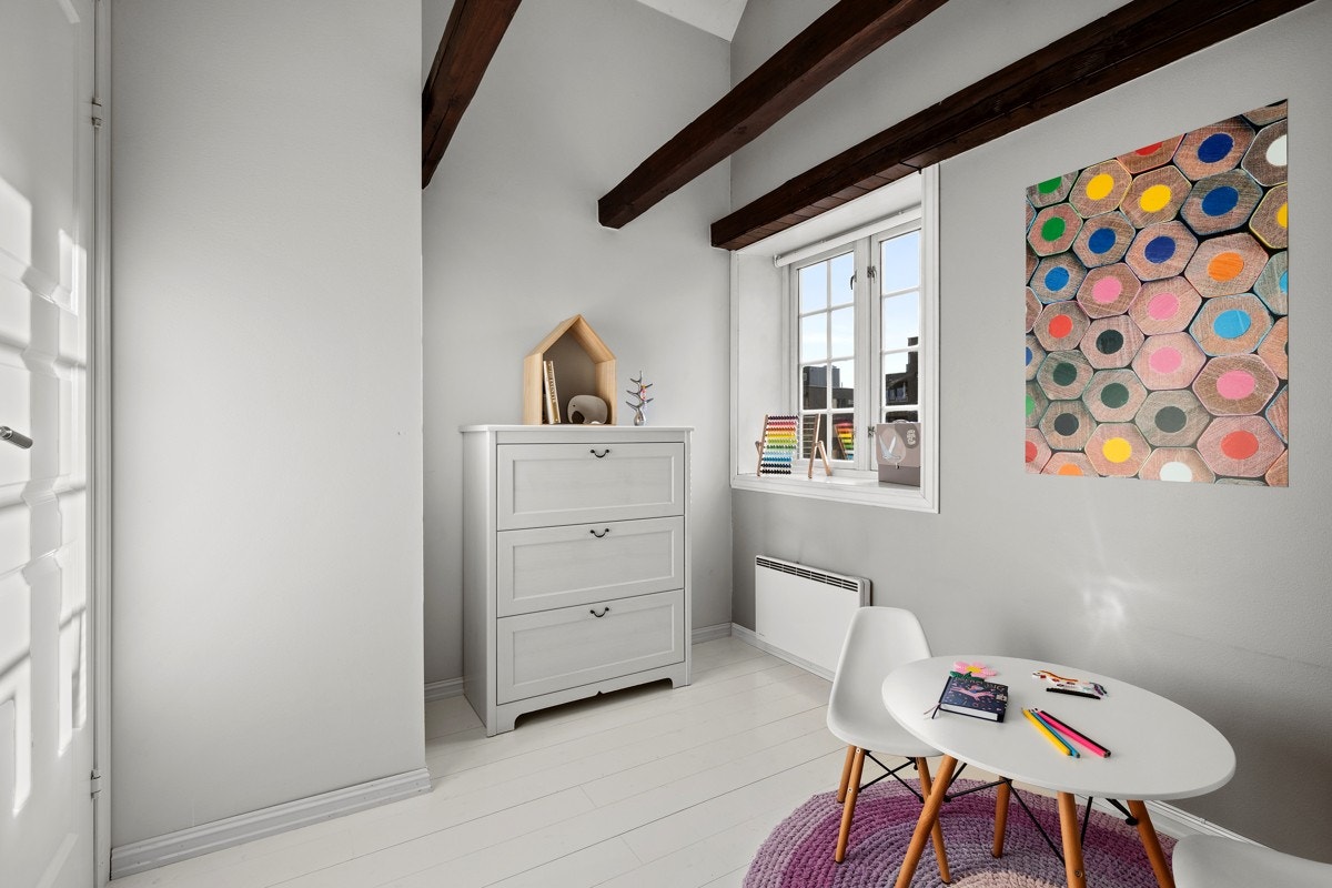 God takhøyde, heltregulv og åpne takbjelker gir soverommet et klassisk preg. Galleribilde