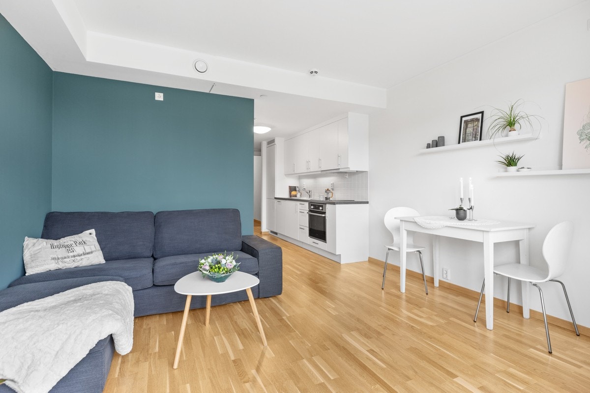 Lys og pen leilighet med moderne kontrastvegger og åpen stue og kjøkkenløsning. Galleribilde