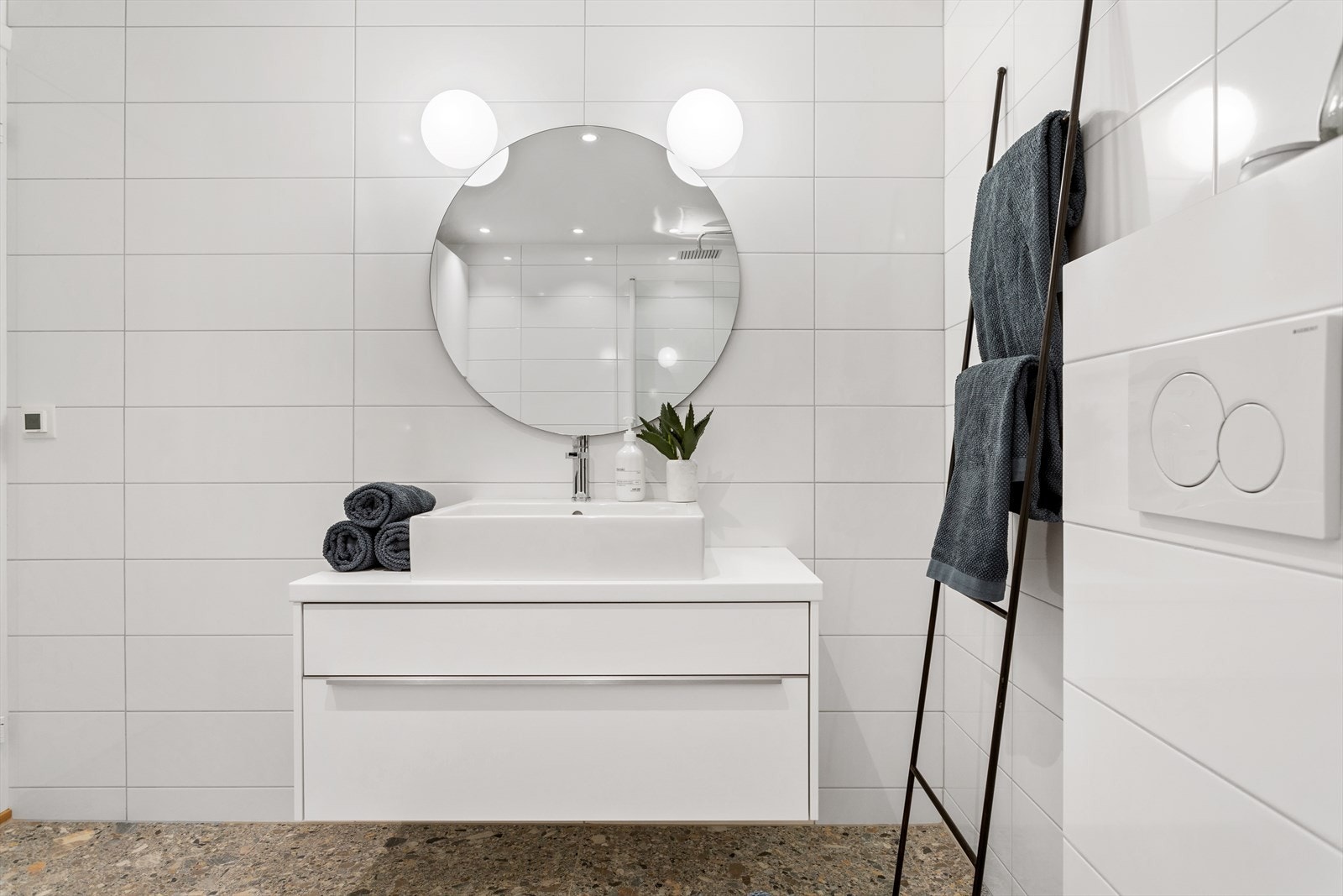 Delikat baderomsmøbel fra Nobilia med skuffer og servant fra Duravit med blandebatteri fra Tapwell. Moderne veggspeil med belysning fra Flos. Forøvrig downlights i taket. Galleribilde