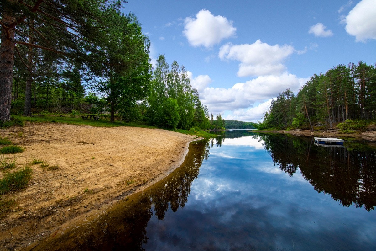 Nede ved vannkanten er det anlagt en koselig lekeplass med sittebenker og en fin sandstrand. Galleribilde