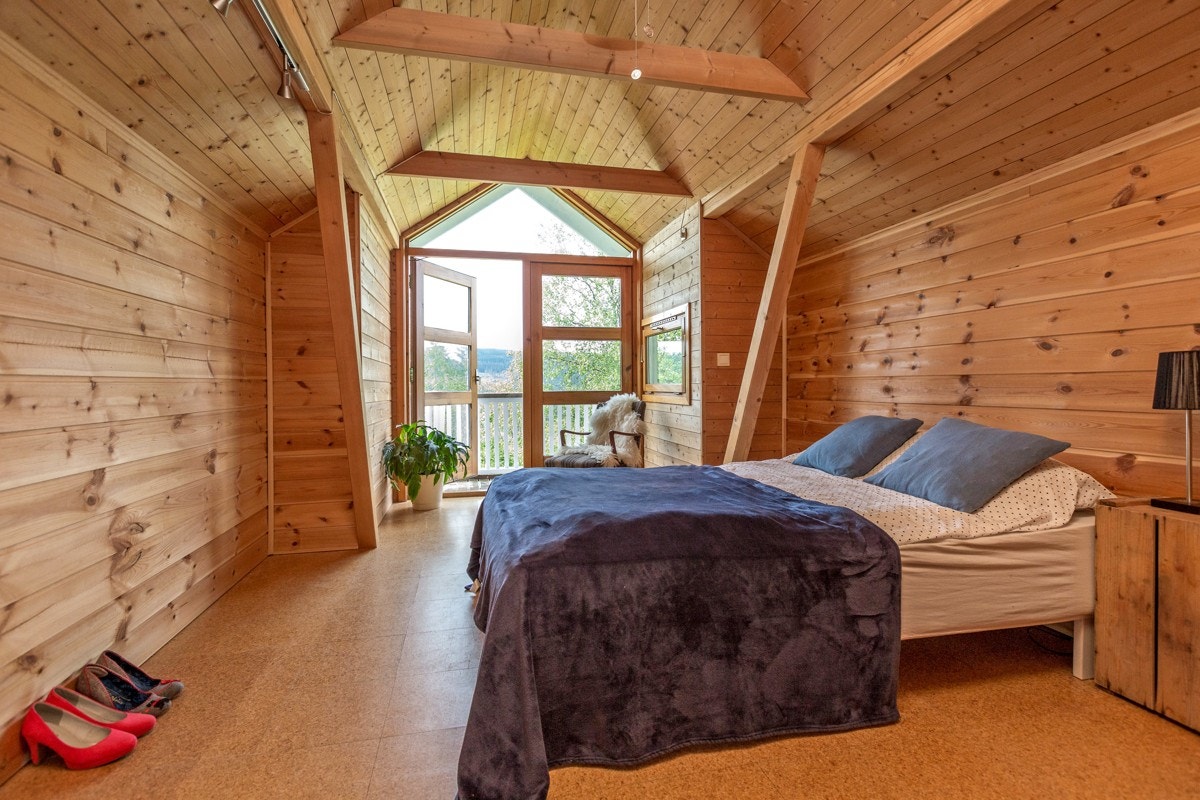 Soverom 1 i 2. etasje med utgang til balkong. Dette er et veldig spennende rom, som med enkle grep kan fungere som en lys stue, kontor eller soverom som benyttet her. Galleribilde