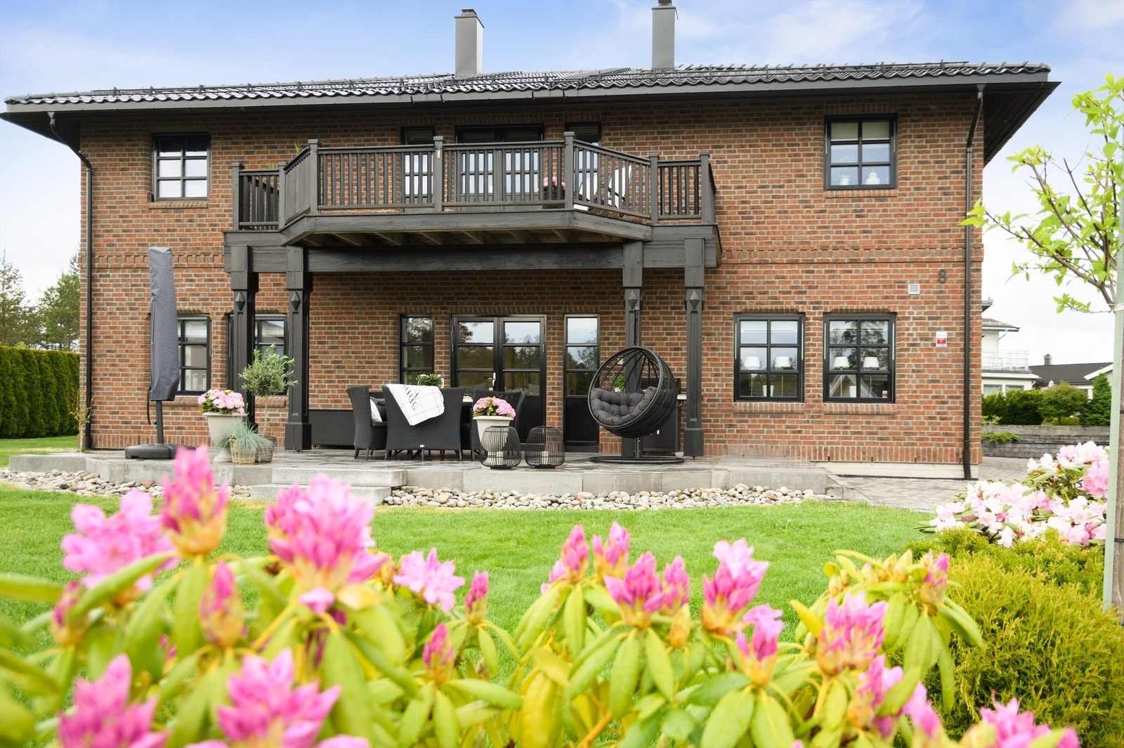 Uterommet innbyr til hygge i solen, her er det stor hage å boltre seg i, samt både støpt terrasse og en lekker balkong Galleribilde