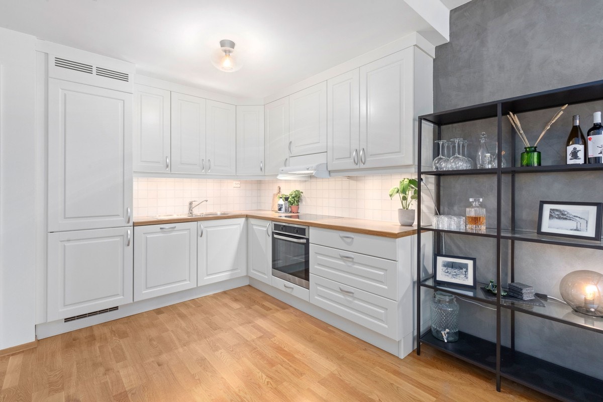 Kjøkkenet har godt med skap og benkeplass samt integrerte hvitevarer som ovn, oppvaskmaskin, ventilator, kjøleskap og frys. Galleribilde