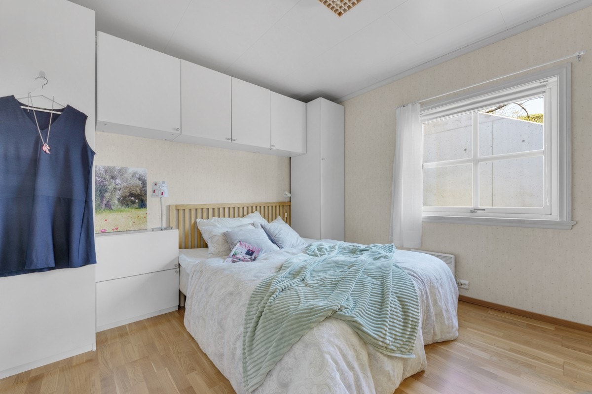 Hovedsoverommet har eikeparkett, malte overflater og vindu vendt mot egen bakhage. Galleribilde