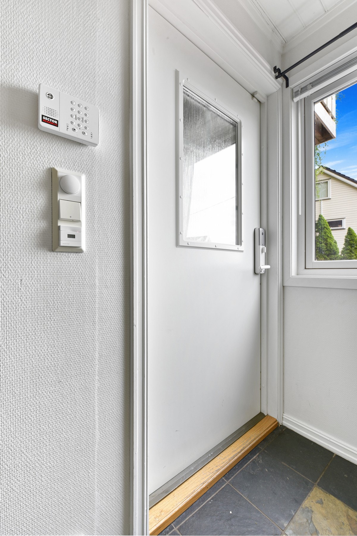 Rommet har blant annet mørke fliser på gulv med varme, downlights i himling, åpen garderobeløsning og hvitmalte veggflater. Galleribilde