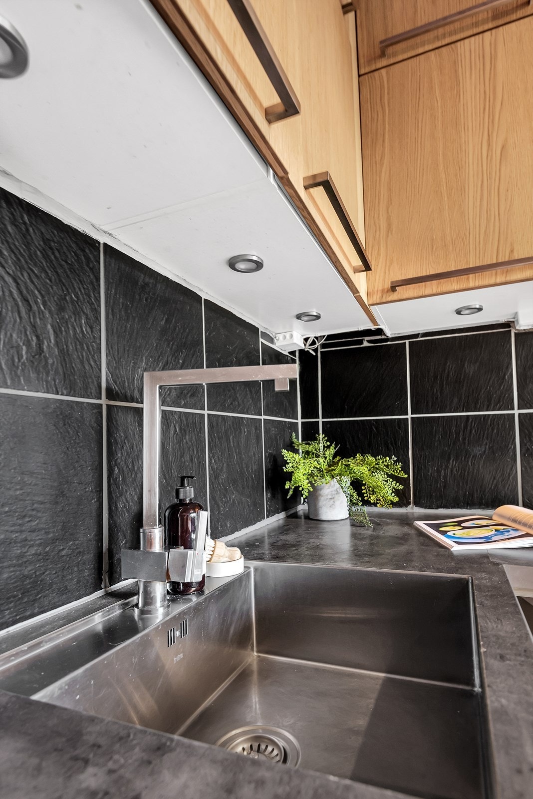 Kjøkkenet har downlights under benkeskap og underlimt vask. Galleribilde