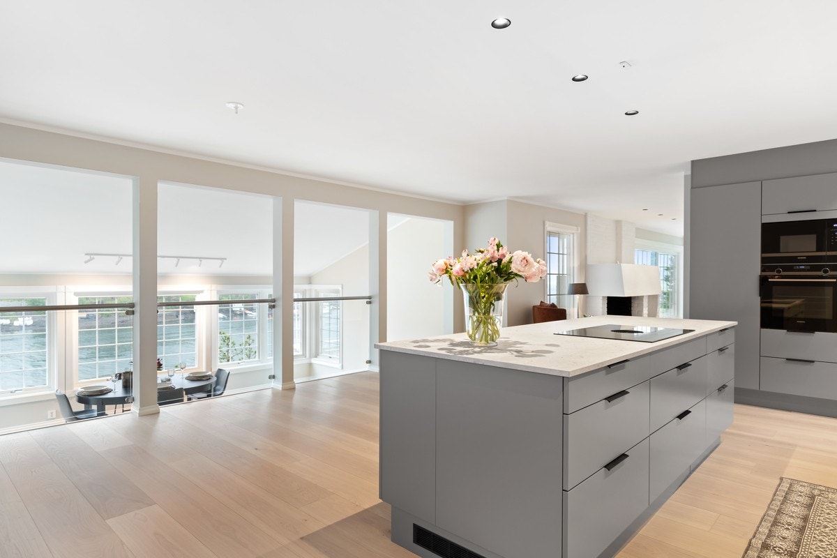 Den åpne løsningen gir en sosial og luftig romfølelse samtidig som halvetasjen gir et klart skille mellom spisestue og kjøkken. Galleribilde