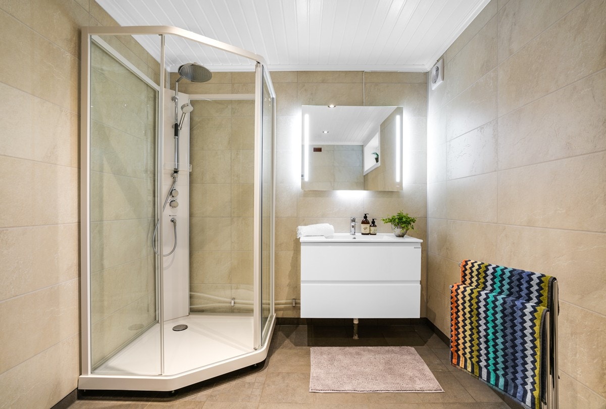 Badet i underetasjen er fra 2019 og har overflater med moderne, pene fliser, gulvvarme og downlights. Galleribilde