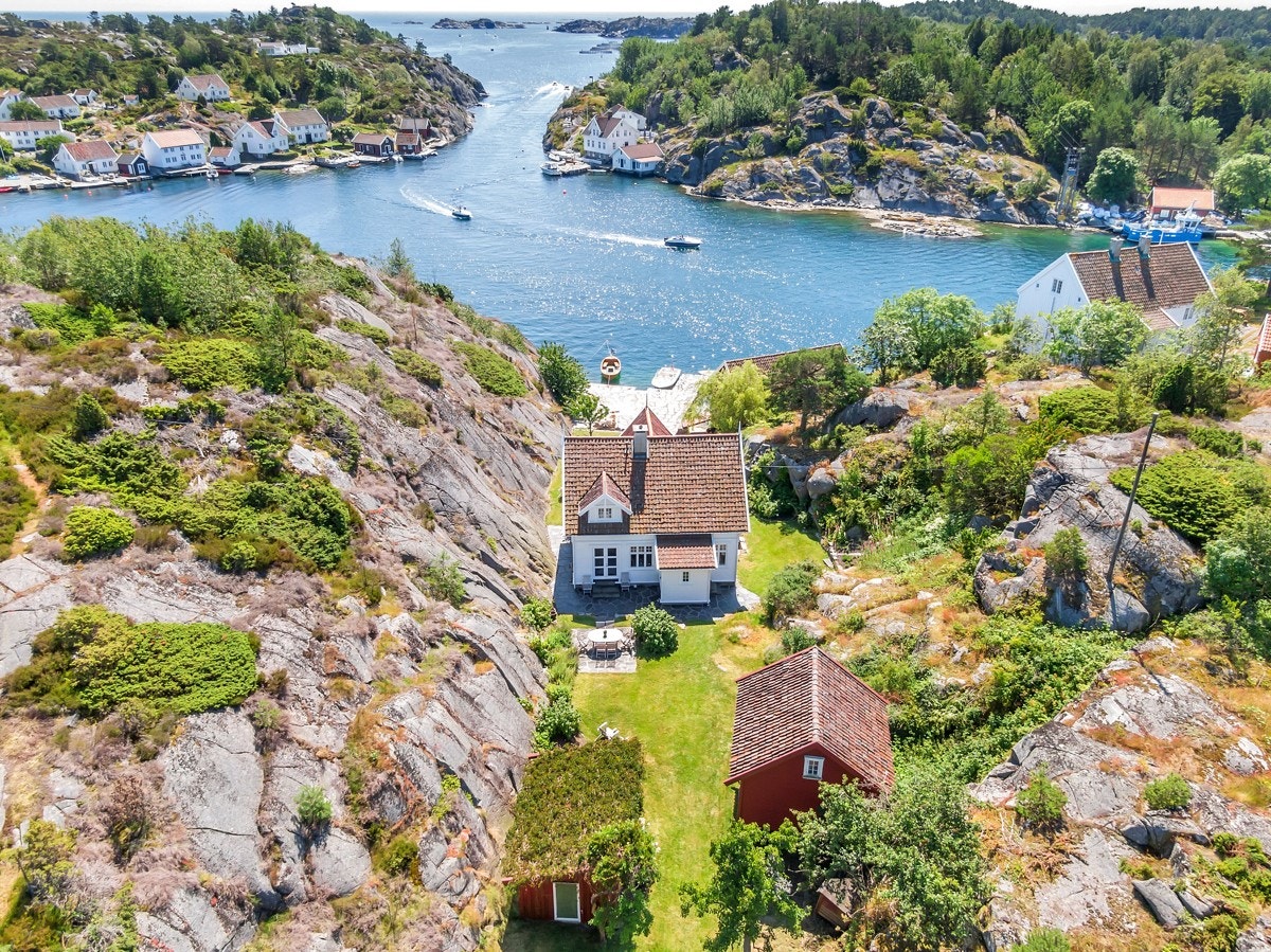 Dronebilde over del av eiendommen med huset, stabburet og annekset i bildet Galleribilde
