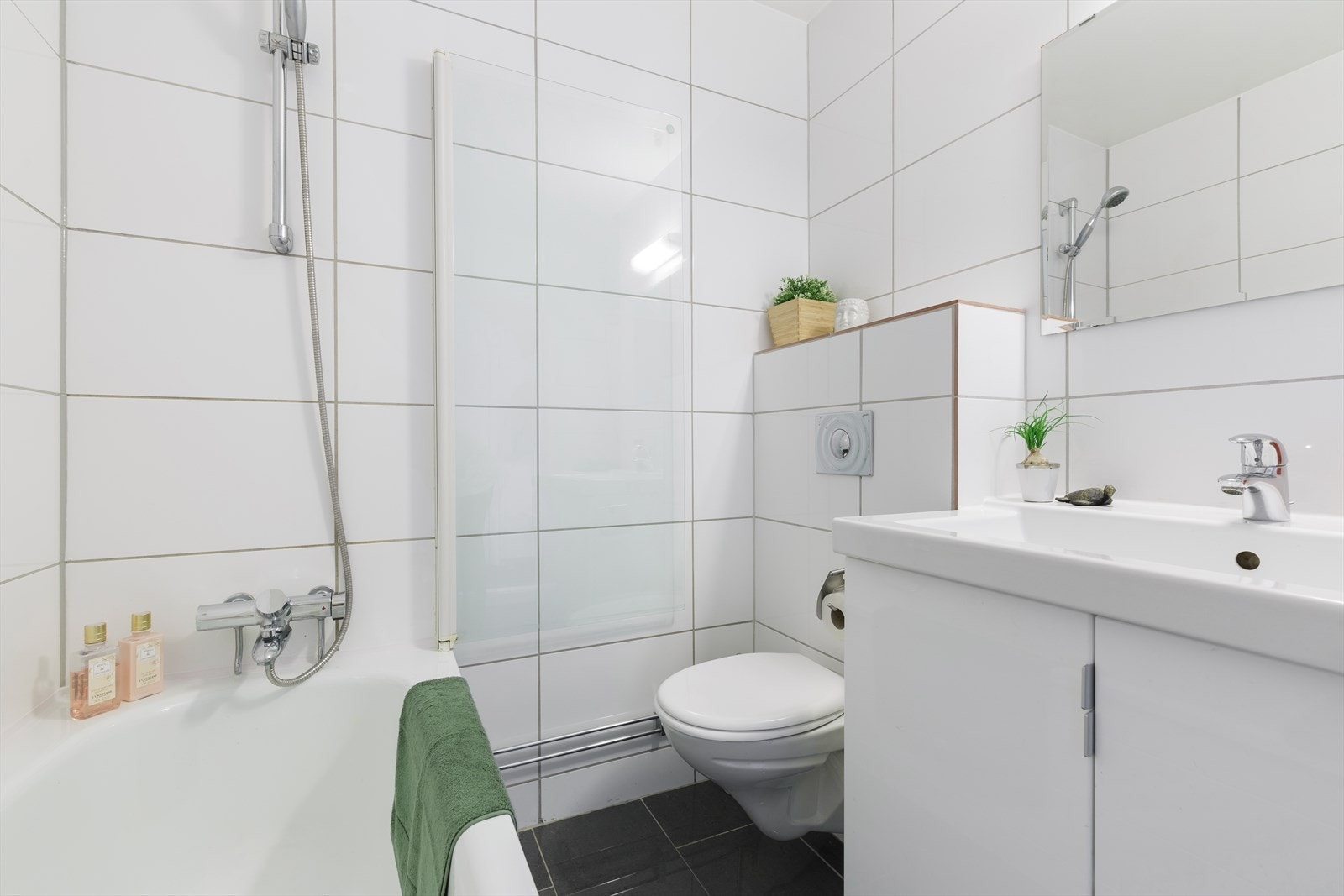 Her er det badekar, vegghengt toalett, servant med servantskap og vaskemaskin. Galleribilde