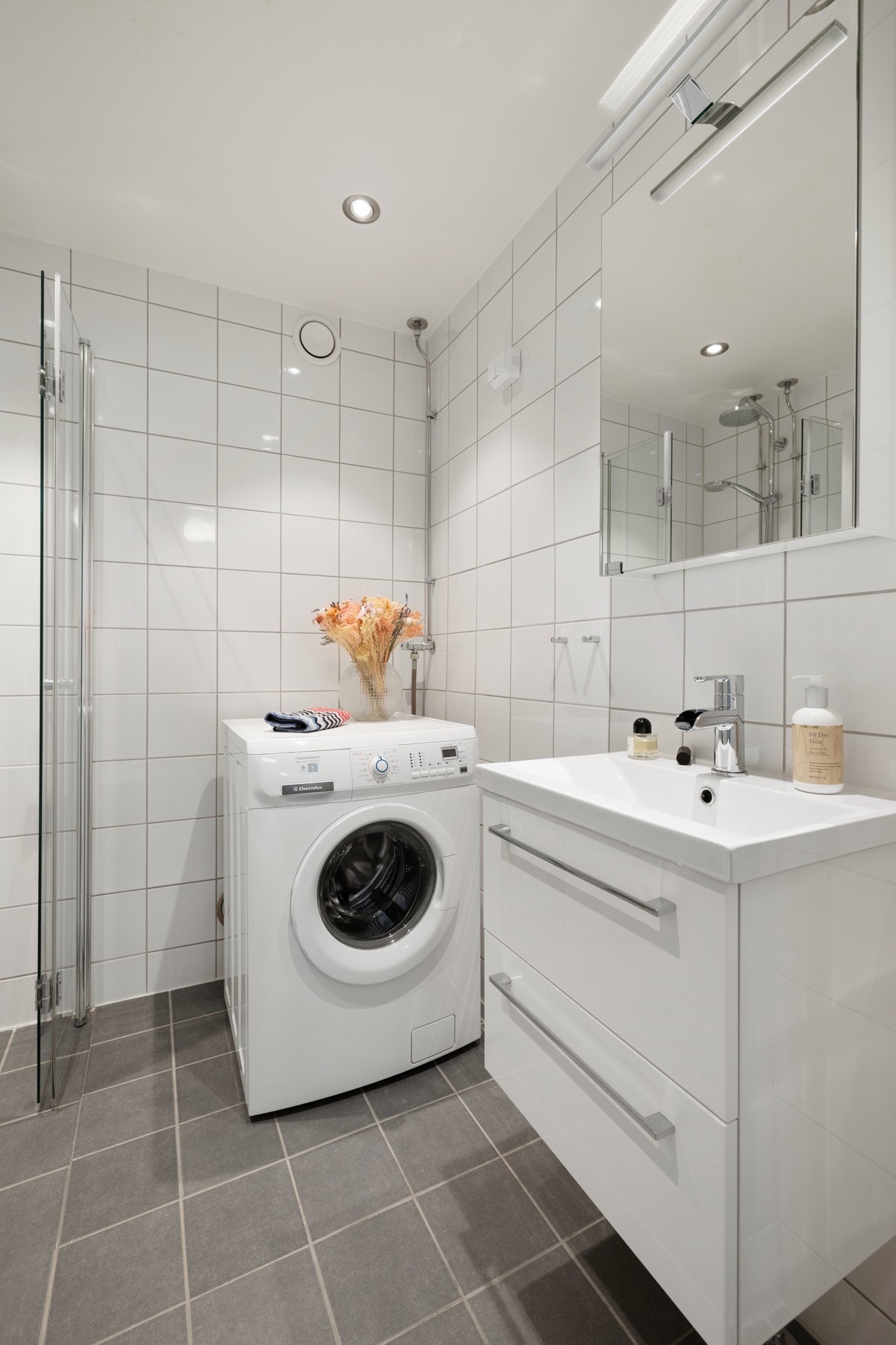 Innredningen består av en praktisk skapseksjon med servant, samt speilskap med lys. Opplegg for vaskemaskin og plass til tørketrommel. Galleribilde