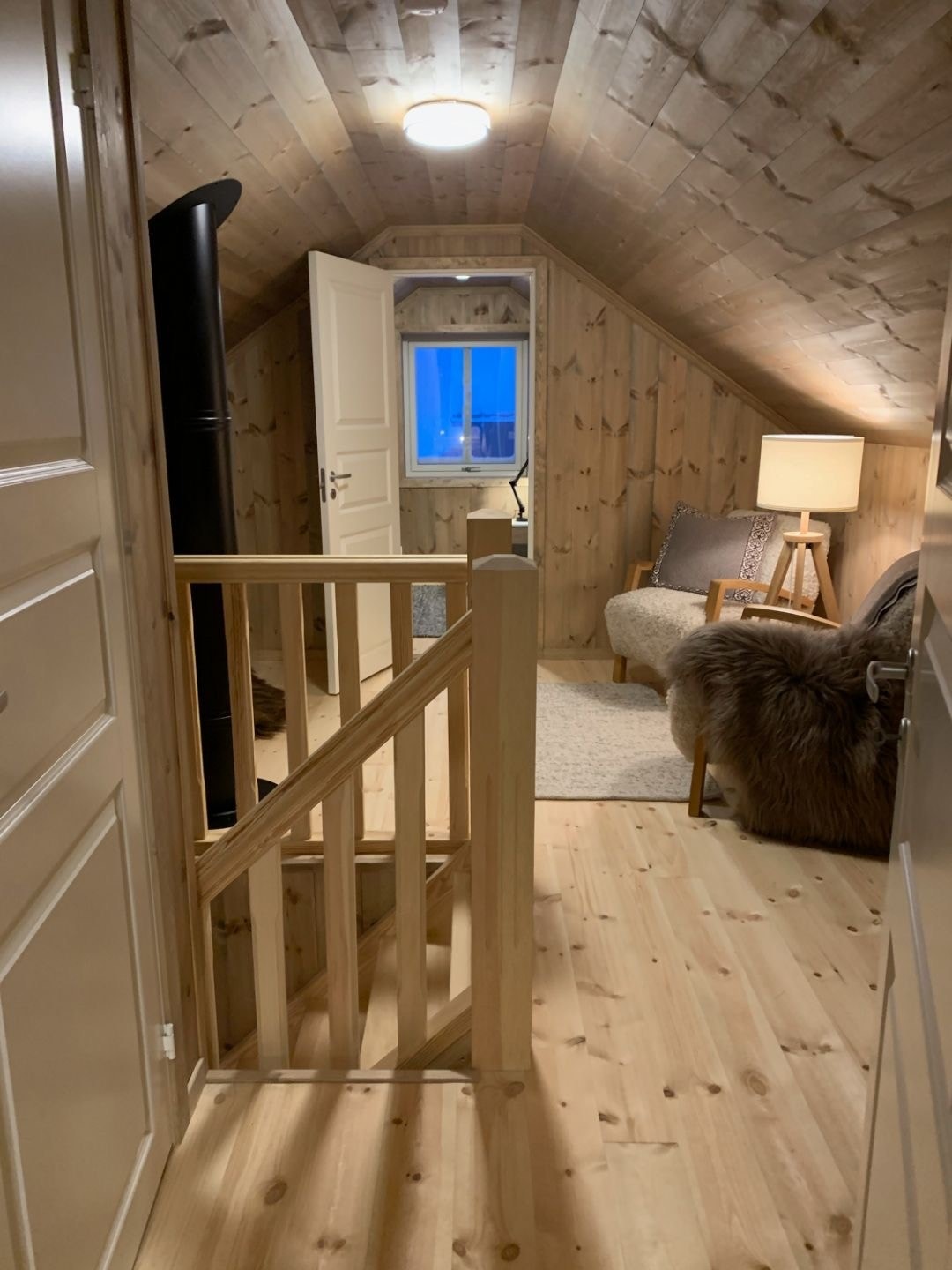 Kundetilpasset innredet hytte med ferdigbeiset panel ellers standard inndeling.
Her av loftstuen med et av soverommene i front og inngang til toalettrom til venstre. Galleribilde