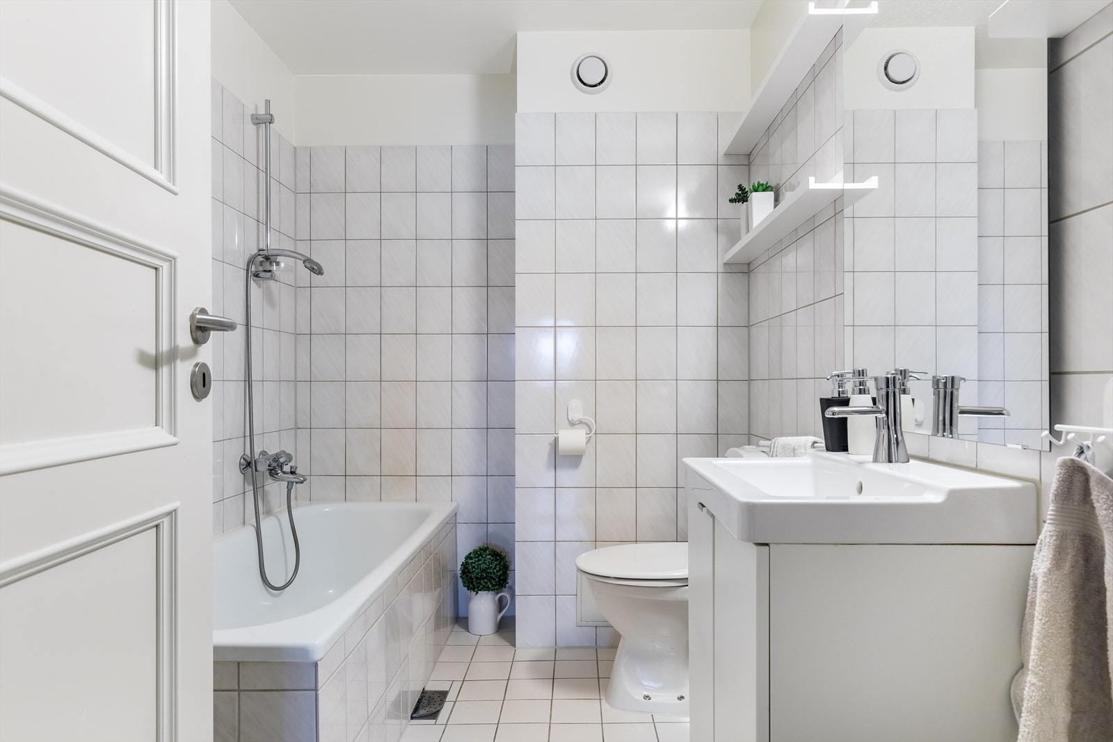 Bad 1 som er utstyrt med servant med ett-greps blandebatteri, wc og badekar med dusjgarnityr. Galleribilde