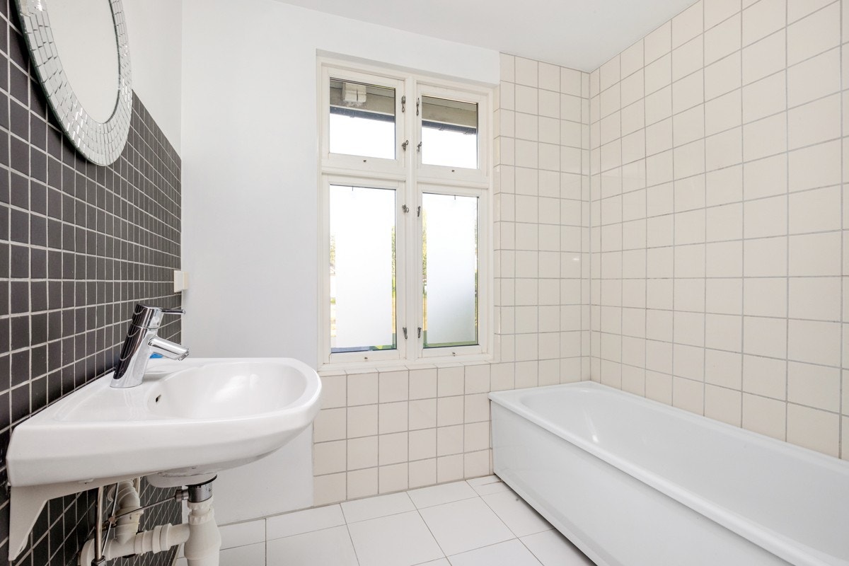 Flislagt bad fra 2001 har badekar, servant og vegghengt toalett. Det er opplegg for vaskemaskin. Galleribilde