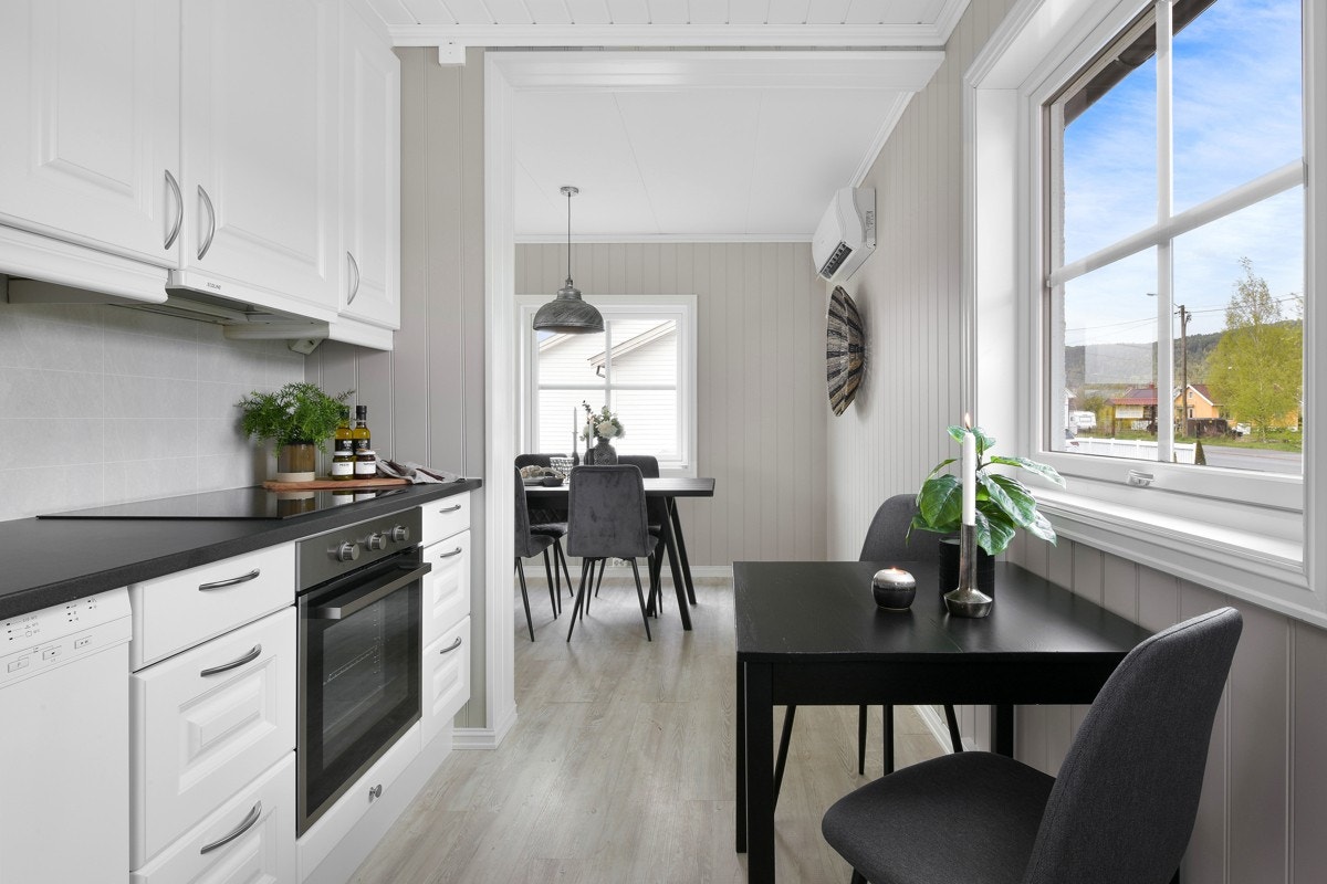 Kjøkkenet har plass til et lite spisebord ved vinduet. Galleribilde