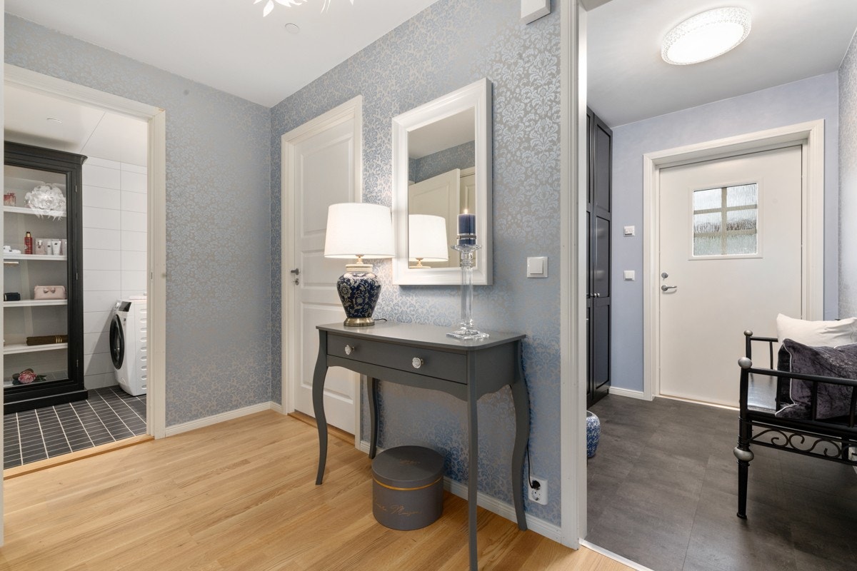 Velkommen inn i en romslig entré med plass for garderobeskap. Galleribilde